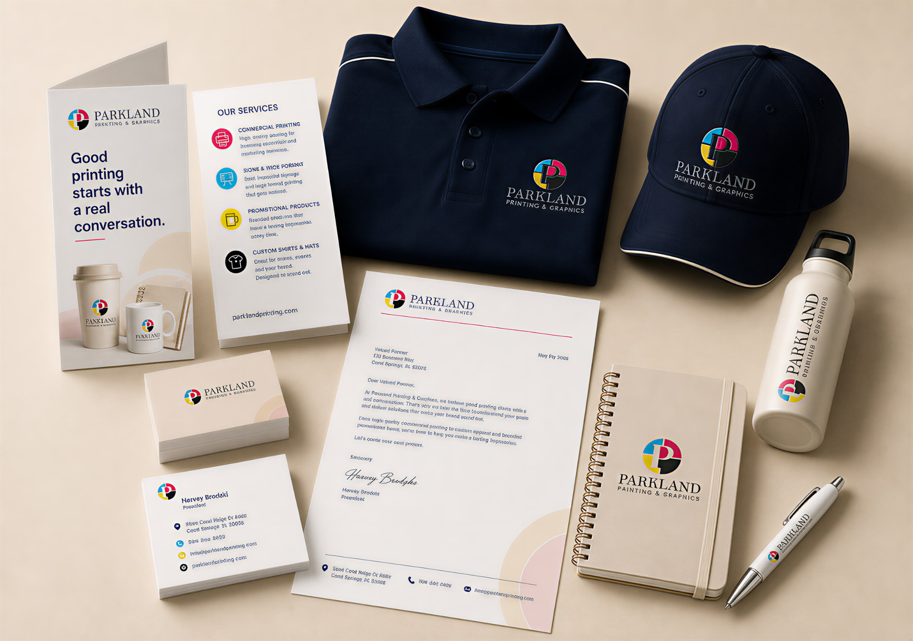 Branded print, apparel, drinkware and stationery arranged as a Parkland Printing & Graphics showcase